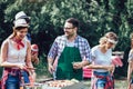 Friends having a barbecue party in nature Royalty Free Stock Photo