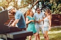 Friends having a barbeque in the backyard. Group of caucasian friends enjoying a sunday evening