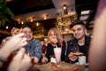 Friends having a coffee together. women and man at cafe, talking, laughing Royalty Free Stock Photo