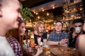 Friends having a coffee together. women and man at cafe, talking, laughing Royalty Free Stock Photo