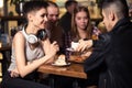 Friends having a coffee together. women and man at cafe, talking, laughing Royalty Free Stock Photo