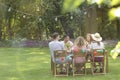 Friends having dinner in the garden during summer time Royalty Free Stock Photo