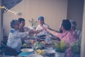 Friends having dinner together toasting and cheering with wine - people having fun and enjoying food and relationship - focus on Royalty Free Stock Photo