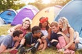 Friends having fun on the campsite at a music festival