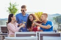 Friends drinking cocktails outdoor on a penthouse balcony Royalty Free Stock Photo