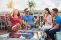 Friends drinking cocktails outdoor on a penthouse balcony Royalty Free Stock Photo