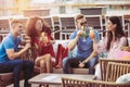 Friends drinking cocktails outdoor on a penthouse balcony Royalty Free Stock Photo