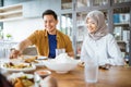 friends having fun eating lunch together at home with traditional food Royalty Free Stock Photo