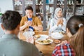 friends having fun eating lunch together at home with traditional food Royalty Free Stock Photo