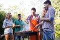 Friends enjoying bbq party and smiling in nature Royalty Free Stock Photo