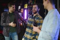 Friends having fun. Happy young men in casual wear drinking beer in pub. Royalty Free Stock Photo