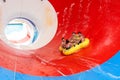 Friends having fun on huge water slide in aqua park Royalty Free Stock Photo