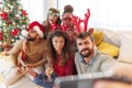 Friends having fun taking selfies while celebrating Christmas at home Royalty Free Stock Photo