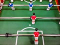 Friends having fun together playing foosball. Colleagues playing table football on break. Office people enjoying table soccer game Royalty Free Stock Photo