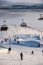 Friends having fun on top of the mountain while skiing/snowboarding. Breathtaking sunset