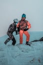 Friends having fun on top of the mountain while skiing/snowboarding.