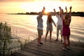 Friends having party at the dock on river at evening Royalty Free Stock Photo