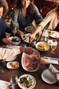 Friends helping themselves to food in restaurant