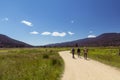 Friends hiking through a meadow in Rocky Mountain National Park, forested mountains in distance Royalty Free Stock Photo