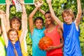 Friends hold arms up at basketball game