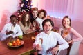 Friends Holding Glasses Sitting At Table Having Christmas Home Party Royalty Free Stock Photo