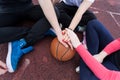 Friends holding hands on basketball Royalty Free Stock Photo