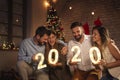 Friends holding illuminative numbers 2020 celebrating New Year Royalty Free Stock Photo