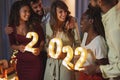 Friends holding numbers 2022 for New Years midnight countdown Royalty Free Stock Photo