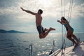 Friends jumping into water from a sailing boat Royalty Free Stock Photo