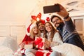 Friends on a large bed, exchanging Christmas presents; enjoying, happy Royalty Free Stock Photo