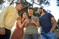 Group of friends laughing with their mobile phones Royalty Free Stock Photo