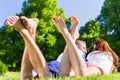 Friends laying with crossed legs