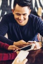 Friends looking at smart phone while sitting in cafe Royalty Free Stock Photo