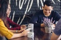 Friends looking at smart phone while sitting in cafe Royalty Free Stock Photo