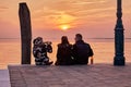 Friends looking at sunset in Burano