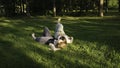 Friends are lying on green grass in park on sunny summer day. Concept. Beautiful girlfriends are lying on green grass in Royalty Free Stock Photo