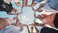 Friends make a heart shape out of their hands. View in motion. Royalty Free Stock Photo