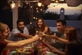 Friends make a toast at a dinner party on a patio, close up Royalty Free Stock Photo