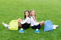 Friends makes you happy. School friends relax on green grass. Happy friends back to school. Classmate friends. School