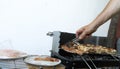 Friends making barbecue and having lunch. Close up of a man making barbeque. Frying meat in the outdoor setting. Grilled shish Royalty Free Stock Photo