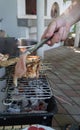 Friends making barbecue and having lunch. Close up of a man making barbeque. Frying meat in the outdoor setting. Grilled shish Royalty Free Stock Photo
