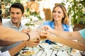 Friends making toast around table