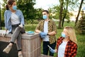 Friends in masks leisures in park, quarantine Royalty Free Stock Photo