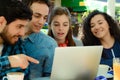 Friends meeting in a coffee shop with a laptop Royalty Free Stock Photo