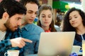 Friends meeting in a coffee shop with a laptop Royalty Free Stock Photo