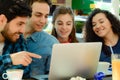 Friends meeting in a coffee shop with a laptop Royalty Free Stock Photo