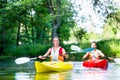 Friends paddling with canoe on forest river Royalty Free Stock Photo