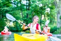 Friends paddling with canoe on river Royalty Free Stock Photo