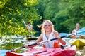 Friends paddling with kayak or canoe on forest river Royalty Free Stock Photo