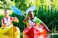 Friends paddling with kayak on forest river Royalty Free Stock Photo